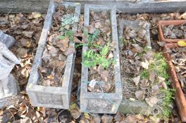 THREE SIMILAR COMPOSITE RECTANGULAR PLANTERS, two with feet 65cm wide the other 60cm wide