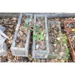 THREE SIMILAR COMPOSITE RECTANGULAR PLANTERS, two with feet 65cm wide the other 60cm wide