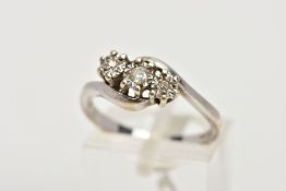 A 9CT WHITE GOLD, THREE STONE DIAMOND RING, of a cross over design, centre round brilliant cut