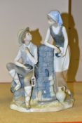 A NAO FIGURE GROUP OF A MAN AND WOMAN BESIDE A WATER PUMP, both eating from a bunch of grapes,
