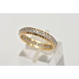 A YELLOW METAL FULL ETERNITY RING, set with colourless spinels, textured gold rim, stamp mark