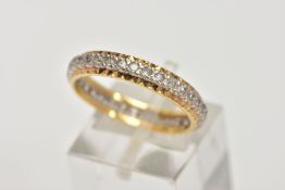 A YELLOW METAL FULL ETERNITY RING, set with colourless spinels, textured gold rim, stamp mark