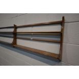 A GOLDEN DAWN ELM HANGING PLATE RACK and a matching dark Ercol plate rack (2)