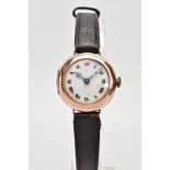 AN EARLY 20TH CENTURY 9CT GOLD WATCH WITH LEATHER STRAP, the circular head with white face and Roman