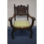 AN EARLY TO MID 20TH CENTURY CARVED OAK CHAIR, with open armrests, foliate decoration, and drop in