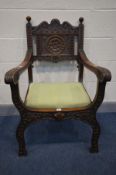 AN EARLY TO MID 20TH CENTURY CARVED OAK CHAIR, with open armrests, foliate decoration, and drop in
