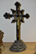 A LATE 19TH CENTURY CARVED WOODEN AND METAL MOUNTED FREESTANDING CRUCIFIX, chip carved detail to