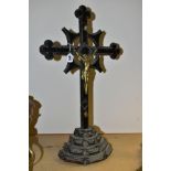 A LATE 19TH CENTURY CARVED WOODEN AND METAL MOUNTED FREESTANDING CRUCIFIX, chip carved detail to