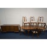 A WALNUT OVAL EXTENDING DINING TABLE, with an additional leaf, open length 212cm x closed length