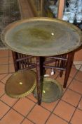 AN INDIAN BRASS TRAY TOP TABLE decorated with bands of script and floral motifs, diameter 59cm,