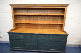 A GREEN PAINTED AND PINE DRESSER, the top with a fixed cornice and two fixed plate racks, the base