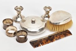 A SELECTION OF SILVER ITEMS, to include two single dwarf candle sticks, each on round weighted