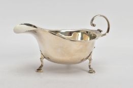 A SILVER 'ASPREY & CO' GRAVY BOAT, plain polished design with a wavy rim, scroll detailed handle,