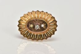 A LATE VICTORIAN GOLD DIAMOND AND SPLIT PEARL BROOCH, the central raised oval panel set with an