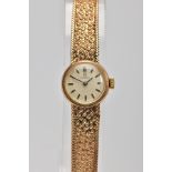 A 9CT GOLD LADY'S OMEGA WRISTWATCH, the circular face with baton hour markers and textured mesh