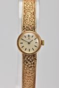 A 9CT GOLD LADY'S OMEGA WRISTWATCH, the circular face with baton hour markers and textured mesh