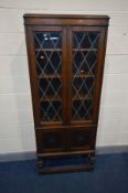 AN EARLY 20TH CENTURY BOOKCASE, with two astragal glazed doors enclosing three adjustable shelves,