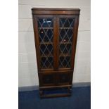 AN EARLY 20TH CENTURY BOOKCASE, with two astragal glazed doors enclosing three adjustable shelves,