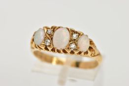 AN EARLY 20TH CENTURY OPAL AND DIAMOND RING, boat shaped design set with three graduated, oval cut