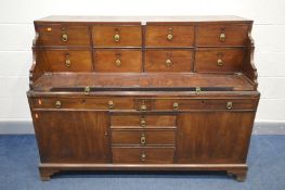 A GEORGIAN AND LATER MAHOGANY DESK, the top section with eight drawers and pull out writing slide,