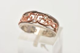 A CLOGAU SILVER AND GOLD RING, designed with a rose gold openwork centre, set with single cut