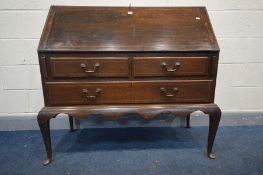 A GEORGIAN OAK AND STRUNG INLAID BUREAU, the fall front with a fitted interior above two short and