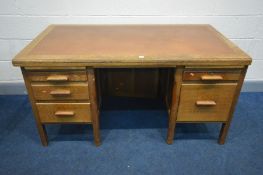 AN EARLY TO MID 20TH CENTURY OAK PEDESTAL DESK, labelled Astrola, with brown leatherette inlay,