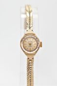 A 9CT GOLD LADY'S ACCURIST WRIST WATCH, the circular face with baton hour markers and chevron design