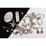 A SELECTION OF SILVER AND WHITE METAL JEWELLERY, to include an oval locket, a charm bracelet