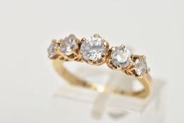 A 15CT GOLD CUBIC ZIRCONIA DRESS RING, designed with a row of five circular cut colourless cubic