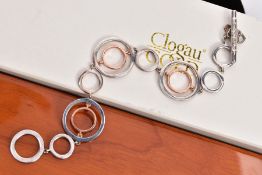 A CLOGAU SILVER AND GOLD BRACELET, openwork rose gold and silver circular links, fitted with a