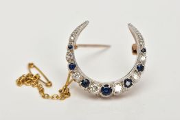 A 9CT GOLD DIAMOND AND SAPPHIRE CRESCENT BROOCH, designed as graduated brilliant cut diamonds