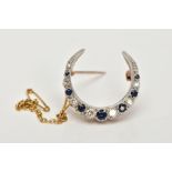 A 9CT GOLD DIAMOND AND SAPPHIRE CRESCENT BROOCH, designed as graduated brilliant cut diamonds