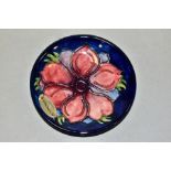 A MOORCROFT POTTERY PIN TRAY, Anemone pattern on blue ground, impressed and painted backstamp, paper