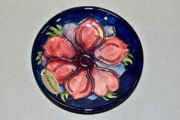 A MOORCROFT POTTERY PIN TRAY, Anemone pattern on blue ground, impressed and painted backstamp, paper