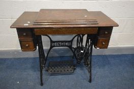 A SINGER TREDLE SEWING MACHINE