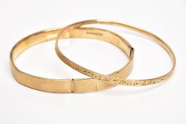 A 9CT GOLD BANGLE AND A YELLOW METAL BANGLE, the first an AF bangle of an engine turned design, (