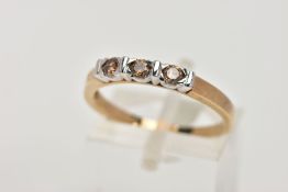 A 9CT GOLD THREE STONE DIAMOND RING, designed with three brown round brilliant cut diamonds,