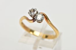 A MID TO LATE 20TH CENTURY TWO STONE CROSSOVER DIAMOND RING. Two early round brilliant cut