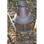 A COPPER CHIMINERE with mesh mid section standing on a steel hooped base 110cm high along with a