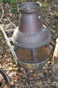 A COPPER CHIMINERE with mesh mid section standing on a steel hooped base 110cm high along with a