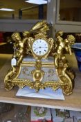 A LATE 19TH CENTURY GILT METAL AND ALABASTER MANTEL CLOCK, the white enamel dial flanked by two