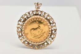 A KRUGERRAND PENDANT, the South Africa 1975 1 oz Krugerrand within a scrolling 9ct gold mount, mount