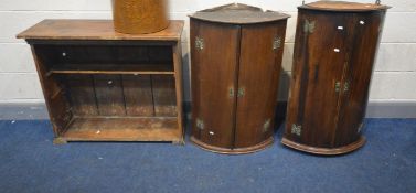 TWO GEORGIAN MAHOGANY BOWFRONT HANGING CORNER CUPBOARDS, along with a distressed open bookcase (3)