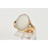 A HEAVY 9CT GOLD OPAL RING, designed with an oval cut opal cabochon, measuring approximately 12.