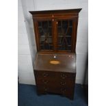 AN EDWARDIAN MAHOGANY AND INLAID BUREAU BOOKCASE, the fall front enclosing a fitted interior,