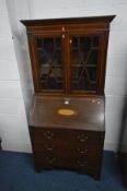 AN EDWARDIAN MAHOGANY AND INLAID BUREAU BOOKCASE, the fall front enclosing a fitted interior,