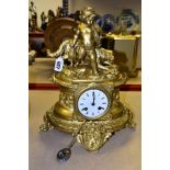 A LATE 19TH CENTURY GILT METAL FIGURAL MANTEL CLOCK, OF OVAL FORM, the surmount cast as a young