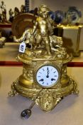 A LATE 19TH CENTURY GILT METAL FIGURAL MANTEL CLOCK, OF OVAL FORM, the surmount cast as a young