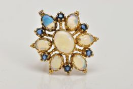 A 9CT GOLD OPAL AND SAPPHIRE BROOCH/PENDANT, designed as a central oval opal cabochon, surrounded by